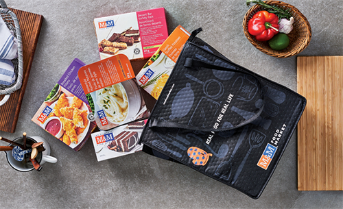 M&M Food Delivery "Real Food for Real Life" bag with products.