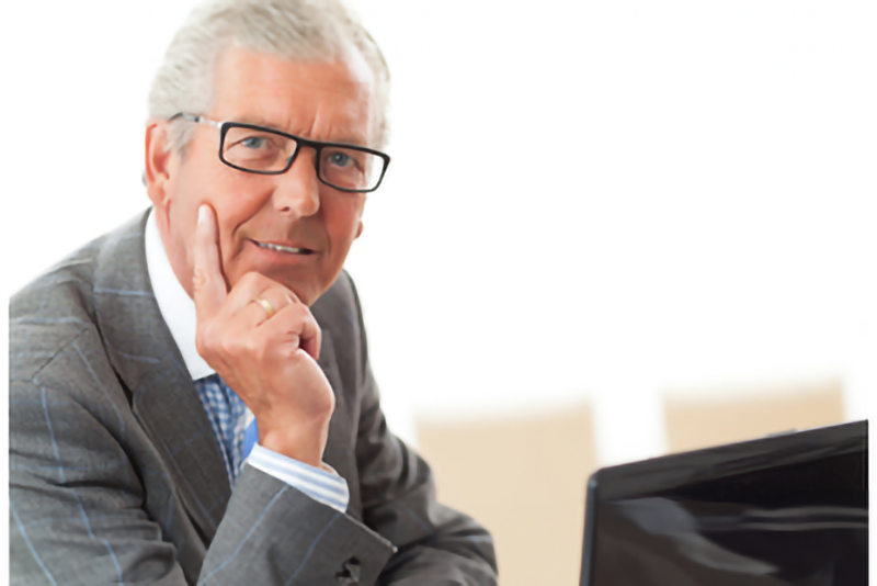 Senior Man with laptop solves employment shortages