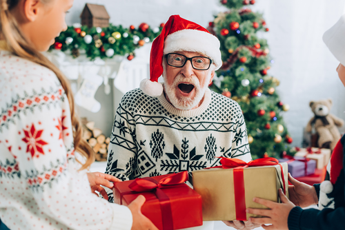 Christmas is for Seniors Too - Delighted senior man receiving Christmas gifts