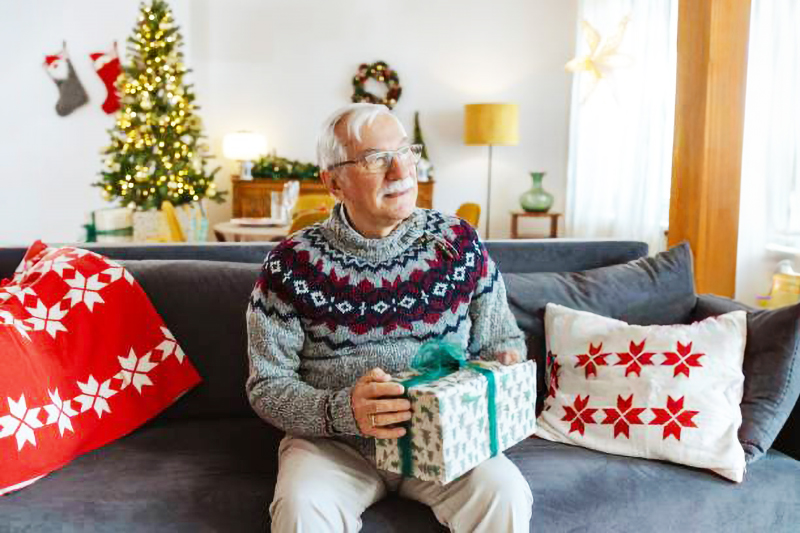 Lonely Senior Receiving a Christmas Gift.