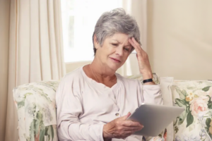 Helping seniors with technology - senior woman frustrated with I-pad